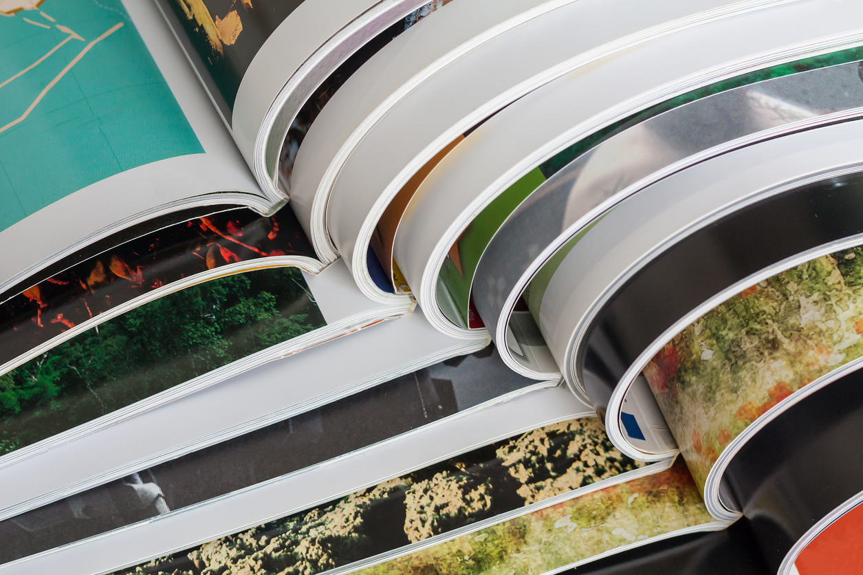 A close-up of a stack of magazines open.