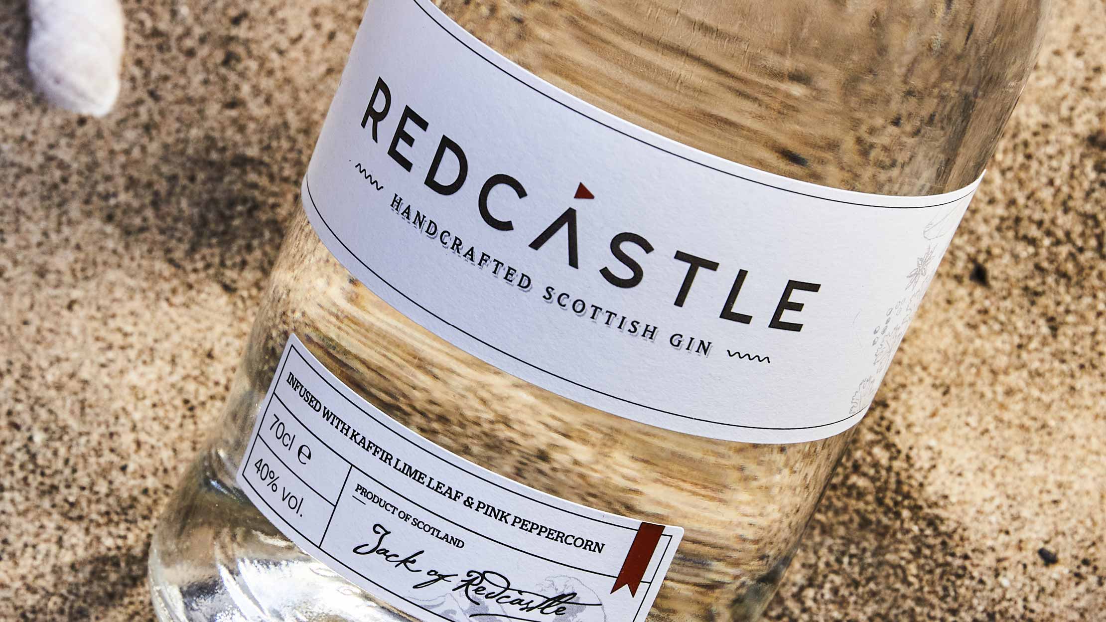 Cream-coloured label on the gin bottle caption "Redcastle".