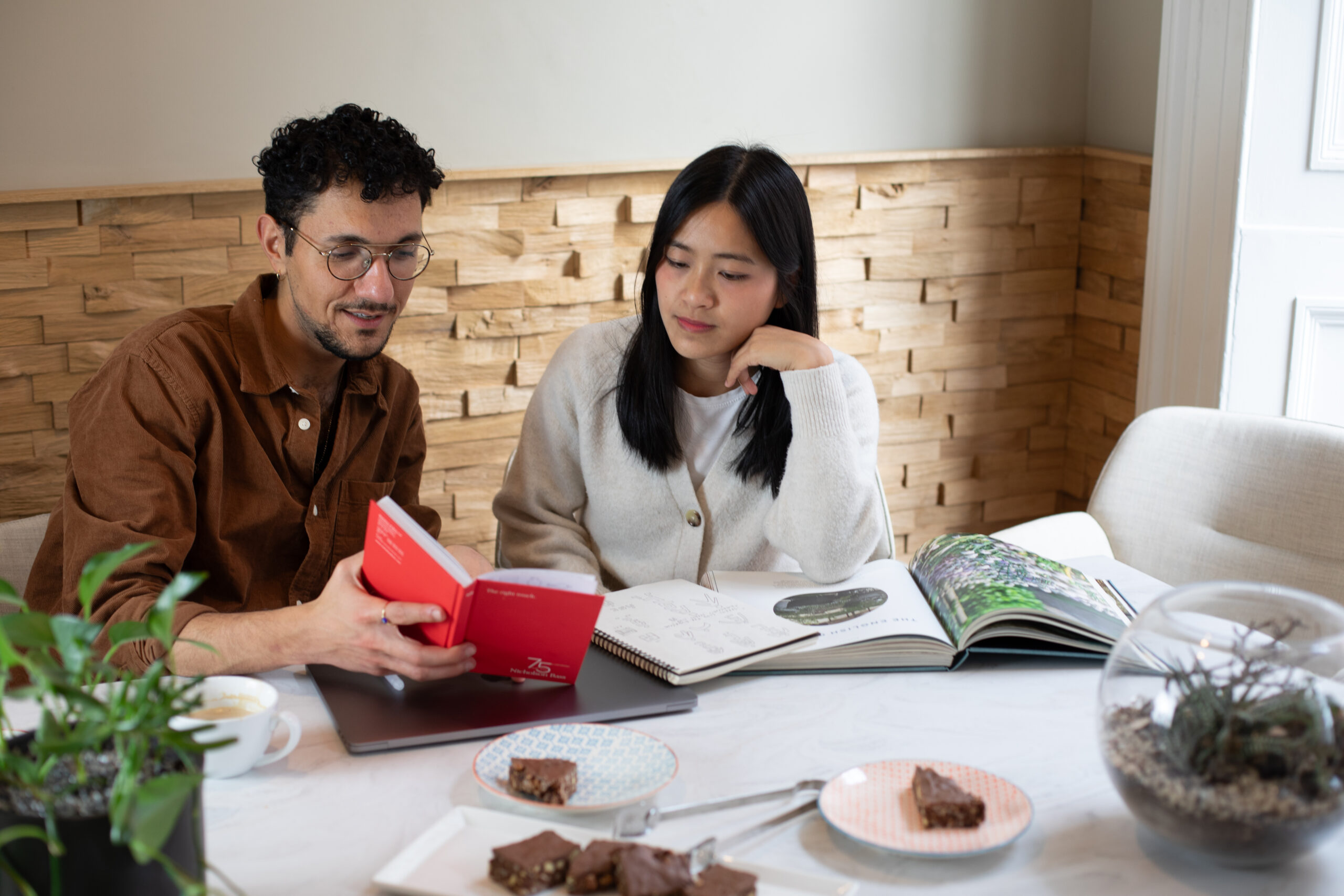 Two designers at a desk discussing work.