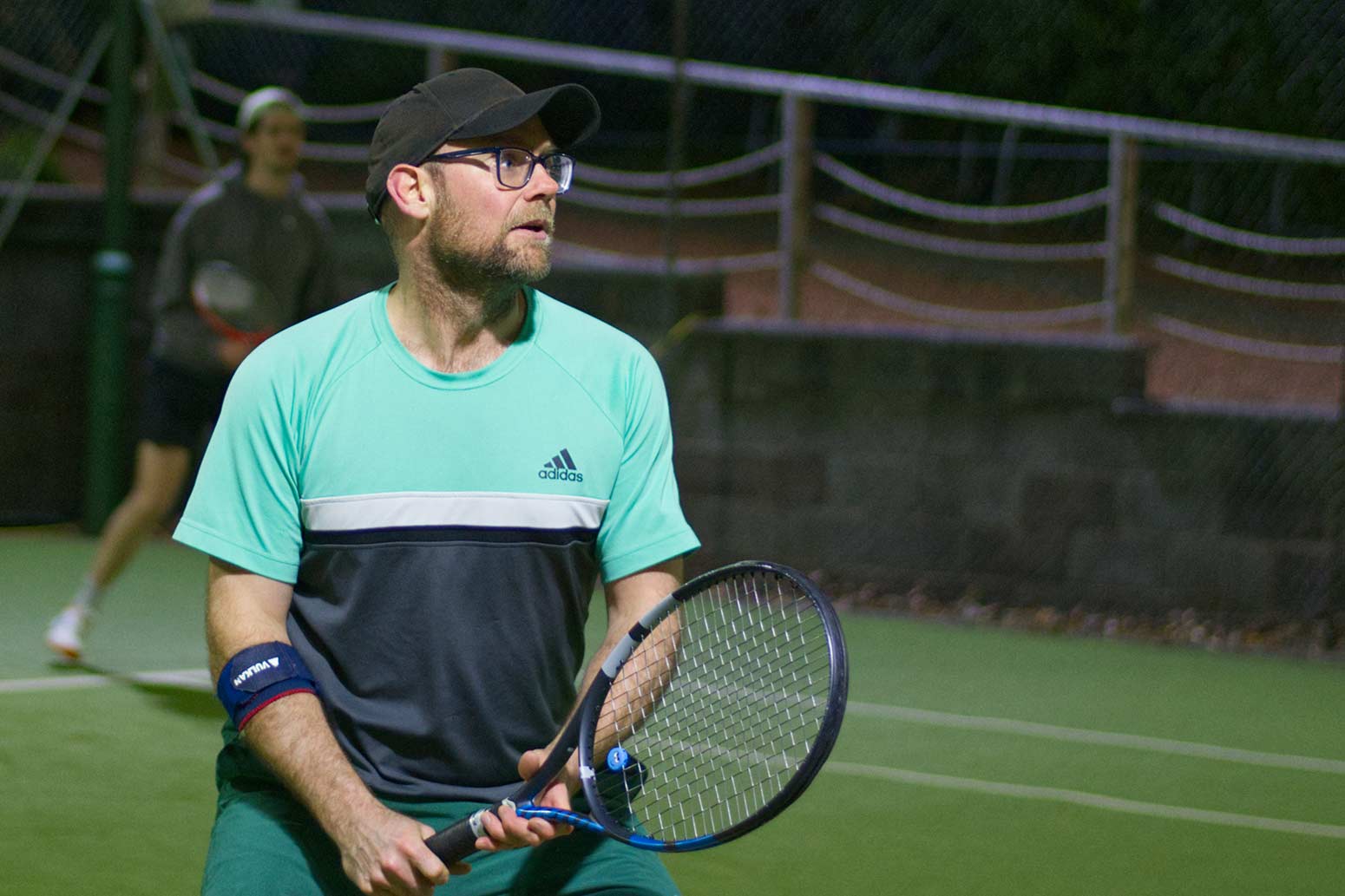 A shot of Firefly's director Ben Walker playing tennis.
